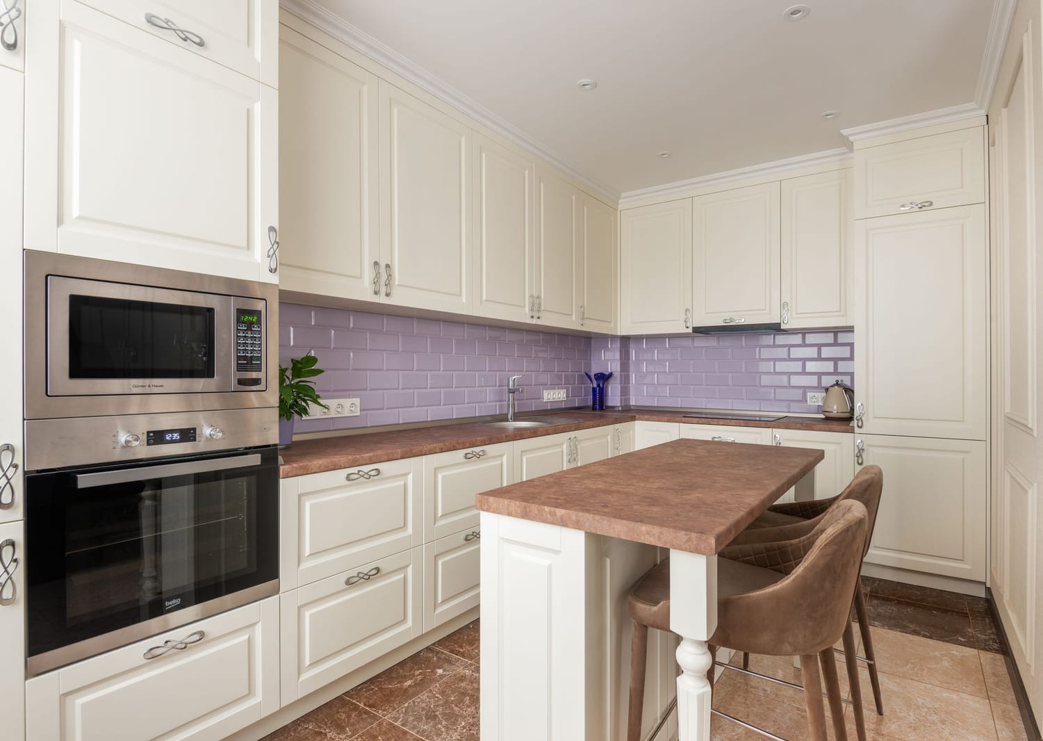 A bright, immaculate kitchen with marble counters — illustrative of a clean, well-sealed kitchen with no pest harbourage